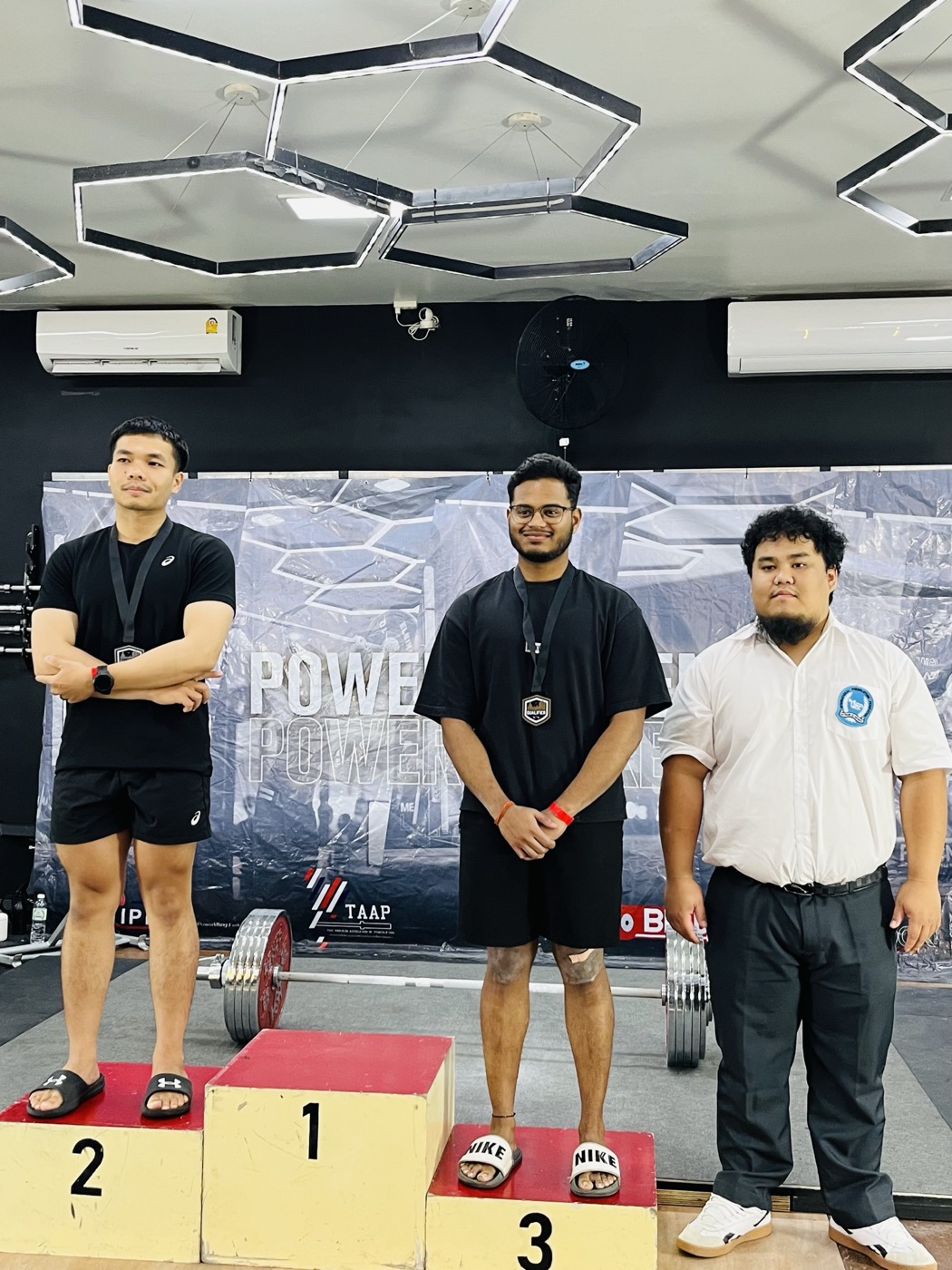 Sai Teja standing on the podium after a powerlifting meet